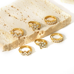 18K gold plated stainless steel flower and zircon hoop earrings set on stone background