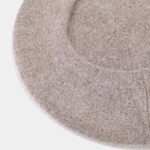 Close-up of spiral knitted pattern on premium wool blend beret in oatmeal color