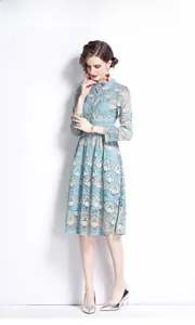 Detailed embroidery on a light blue lace dress with long sleeves and elegant floral pattern