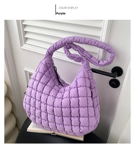 Detail of lavender puff shoulder bag showing soft quilted fabric and nylon texture