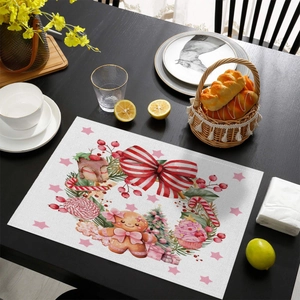Close-up of Christmas placemat with pink gingerbread man and festive fabric texture