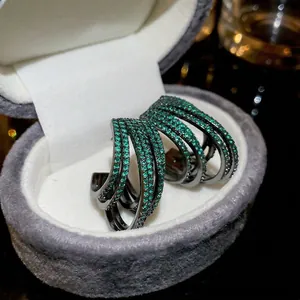 Multilayered green zircon C-shape hoop earrings with black gunmetal finish for women