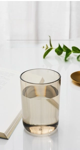 Detailed view of a brown translucent cylindrical mouthwash cup with a thick base