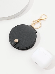 Close-up of black PU leather round keychain mirror with a gold metal clasp and ring