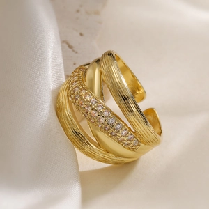 Irregular geometric 18K gold plated layered ring with pavé zircons on white fabric