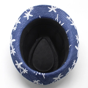 Detail of navy blue straw Panama hat with white palm tree print and black sweatband