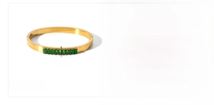 Detail view of 6mm width 18k gold plated stainless steel bangle with green zircon inlay