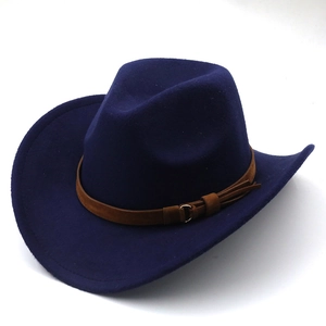 Detail of navy blue felt cowboy hat featuring a brown suede band with a golden buckle