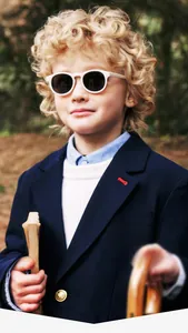 Classic white round silicone sunglasses for kids on a model in natural soft sunlight