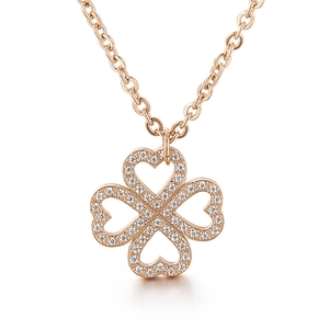 Elegant rose gold clover necklace with heart-shaped pendants and sparkling crystals
