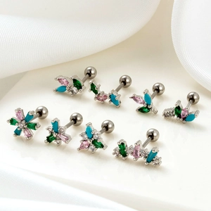 Detailed flat lay of stainless steel cartilage studs with colorful zircon inlays