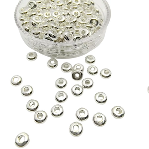 Macro shot of silver metal spacer beads for DIY jewelry making on white background