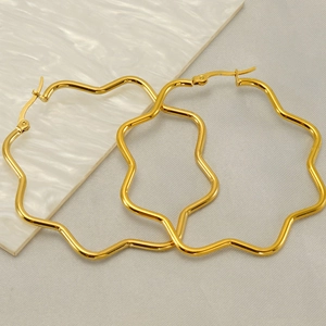 Minimalist 18K gold plated stainless steel wavy hoop earrings for women on marble surface