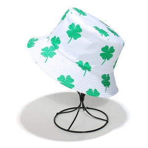 Close-up of white bucket hat with green shamrock print for St. Patrick's Day theme