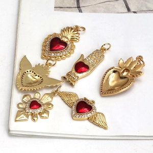 Set of 6 gold sacred heart and hamsa hand pendants with red heart stones and zircons
