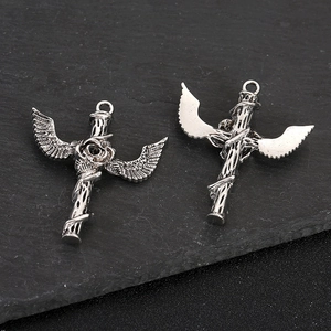 Vintage zinc alloy cross pendants with wings and rose motifs on black background