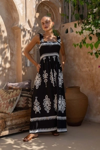 Detail of bohemian black and white ethnic print on a flowy strapless maxi beach dress