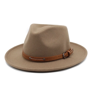 Close-up of light brown wool fedora with a leather strap, silver buckle, and metal rivets