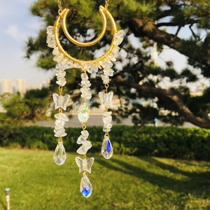 Detailed close-up of crystal suncatcher with hanging water drop beads and moon decor