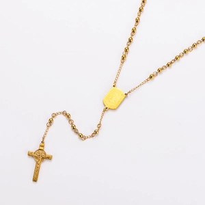 Detailed close-up of golden stainless steel rosary necklace with cross and medal