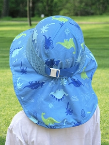 Close-up of kids dinosaur sun hat with neck flap, breathable mesh and adjustable strap