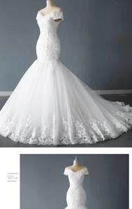 Détail d'une robe de mariée sirène à épaules dénudées avec dentelle et broderie de paillettes