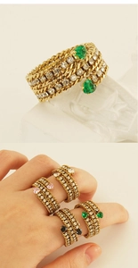 Detail of 18k gold multilayer chain ring featuring heart gems and white cubic zirconia