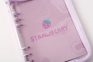 Detail of A5/A6 PVC binder cover with purple piping and glitter strawberry design