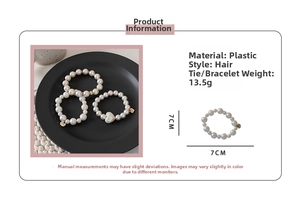 Detailed view of vintage pearl hair ties set with heart pendant in creamy white finish