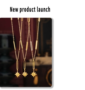 Detail of gold star pendant necklaces with long bar links and sparkling crystal center