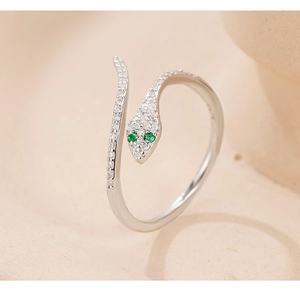 Macro detail of S925 silver snake ring with green gem eyes and pavé cubic zirconia
