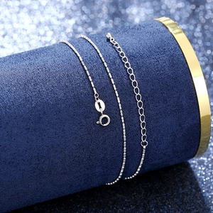 Macro shot of S925 sterling silver beaded chain with adjustable clasp on blue display