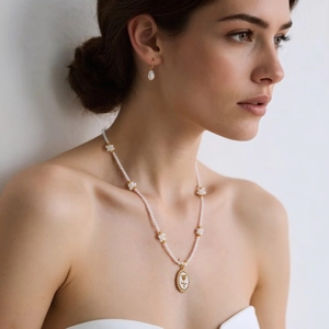 Elegant floral pearl necklace and teardrop pearl earrings set in gold and white finish