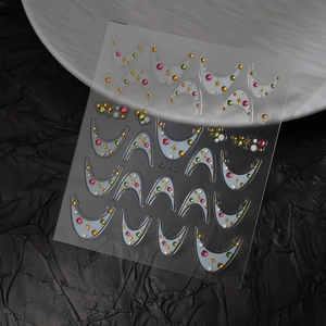 Detail of Co-470 crescent moon nail art stickers with colorful rhinestones and gold stars