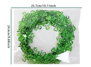 Detail view of St. Patrick's Day green clover tinsel garland with packaging dimensions