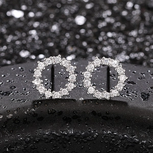 Macro view of silver hollow circular stud earrings with shimmering clear cubic zirconia