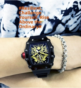 Macro detail of tonneau men's watch featuring a gold skeleton dial and red crown
