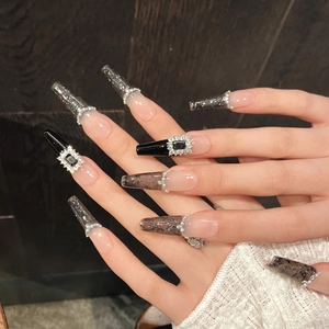 Long coffin black French press-on nails with glitter gradient and pearl rhinestone accents