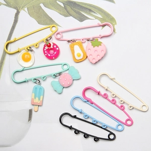 Close-up of colorful 6cm safety pins with cute food charms like donuts and ice cream