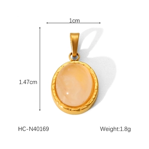 Macro view of oval pink natural stone pendant with gold stainless steel rim and dimensions