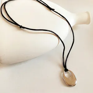 Minimalist silver oval hollow pendant necklace with adjustable black cord for women