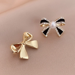 Vintage bow earrings with black enamel, pearl accents and pavé rhinestones in gold tone