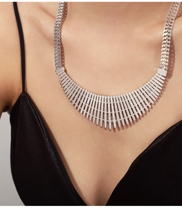 Silver fringe statement necklace with zircon inlay on elegant black satin dress