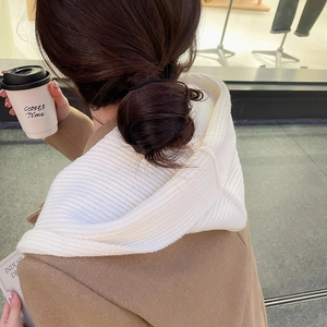 Detailed close-up of a white ribbed knit hooded scarf showing premium wool texture