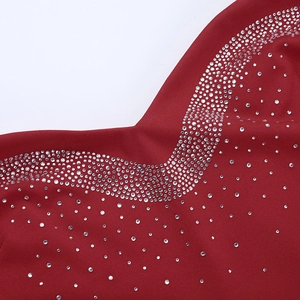 Detail of red satin dress featuring luxurious silver rhinestones and premium fabric texture
