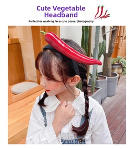 Detail of creative red chili vegetable headband with a soft black velvet hairband strap