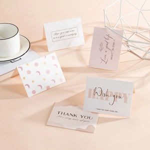 Minimalist greeting cards with elegant designs on a soft pink background with decor