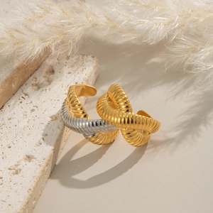 Textured 18k gold plated criss-cross chunky hoop earrings on a natural stone base