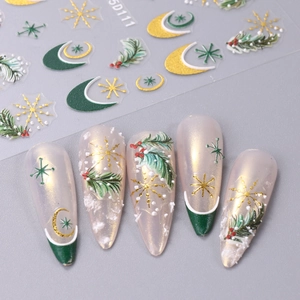 Close-up of 5D Christmas nail stickers with gold stars, moon, and pine branch designs