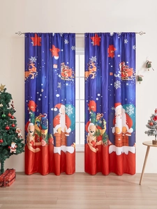 Detailed close-up of blue Christmas curtains with Santa and reindeer in a cozy room